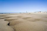 a panoramic view of blackpool sands at low tide with the tower andd central pier in the distance.
