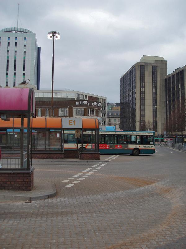 Depressing view of Central Bus Station in Cardiff Depressing view of the Central Bus Station in Cardiff with rows of shelters and a departing bus on a dismal grey cloudy day
