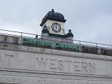 Old Clock on Top of the main Building with Carvings on the Wall at Cardiff Central Station, Wales.