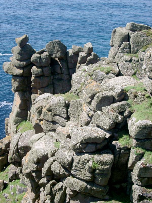 erroded rock formations weathered by countless storms over the headland and lands end, cornwall