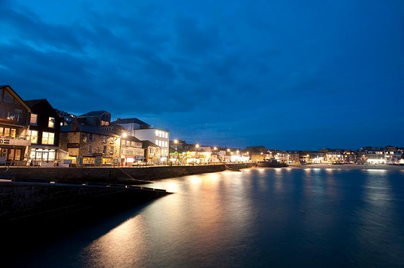 a night time view of the quayside of saint ives harbour, cornwall
