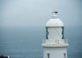 a foggy day looking out to sea at the pendeen lighthouse, cornwall