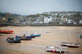 fishing boats at low tide in the harbour at saint ives, cornwall