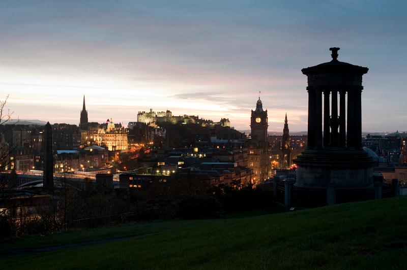 A view of edinburgh at nght from carlton hill with the Dugald Stewart Monument in the foreground