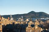 buildings in edinburgh, with salsbury crags and arthurs seat hill behind