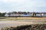 Landscape view of the coastal town of Anstruther, Fife, Scotland looking across the beach to waterfront houses at low tide