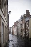 Rainy day in Cellardyke, Scotland with a view down a narrow winding street with historic houses