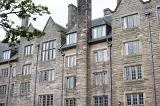 Four story apartments with old stone walls and casement windows in Saint Andrews, Scotland
