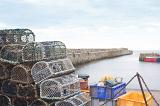 Old wire crab and lobster pots on the quay overlooking the harbour, St Andrews, Scotland