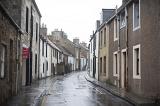 Lovely Scottish village as rain falls on street lined with pretty row homes