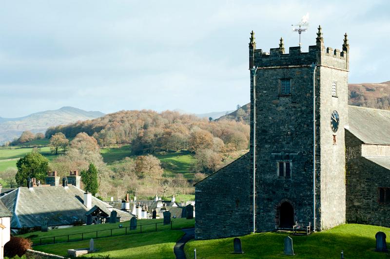 A view of the hawkshead church on a hill overlooking the village and beautiful surrounds