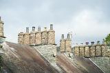 Traditional cylindrical stone chimney pots on the rooftops of the cottages in Skelwith Bridge, a village in the Englsih Lake District in Cumbria
