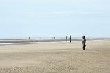 Another Place by Antony Gormley, Crosby Beach, Liverpool with 100 cast iron statues standing facing out towards the ocean