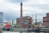 Old power plant with ship at Liverpool Waterfront under overcast sky in the United Kingdom