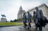 Statues of the Beatles walking near the Liver Building in Liverpool, United Kingdom