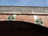 Old brick railway arch on a viaduct at Castlefields, Manchester, Lancashire against a clear sunny blue sky
