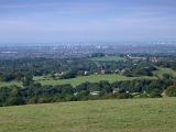 Lush English countryside looking towards the city of Manchester in the distance with the view encompassing the whole city