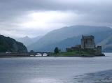 Eilean Donan castle on an island in Loch Duich, Scotland with its old arched bridge connecting it to the mainland