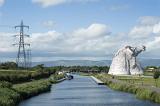 Scenic view of Falkirk Scotland with kelpies sculpture of horse heads on right side of the canal