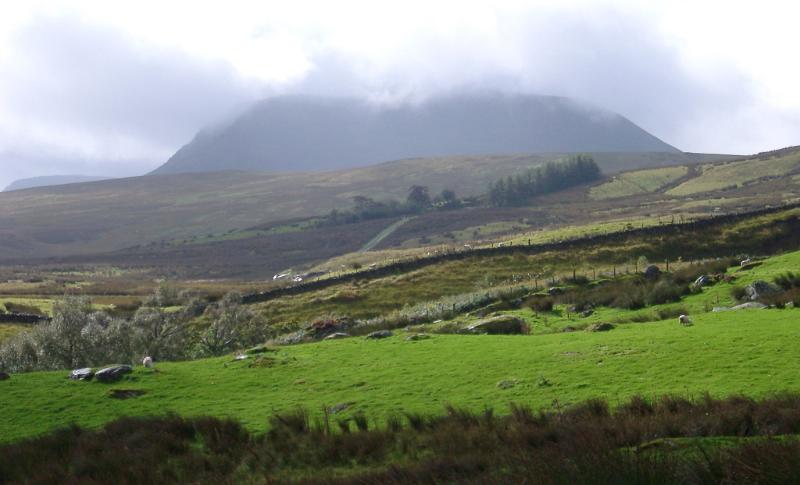 Wet weather in the Welsh hills with low cloud cover and mist over lush green countryside