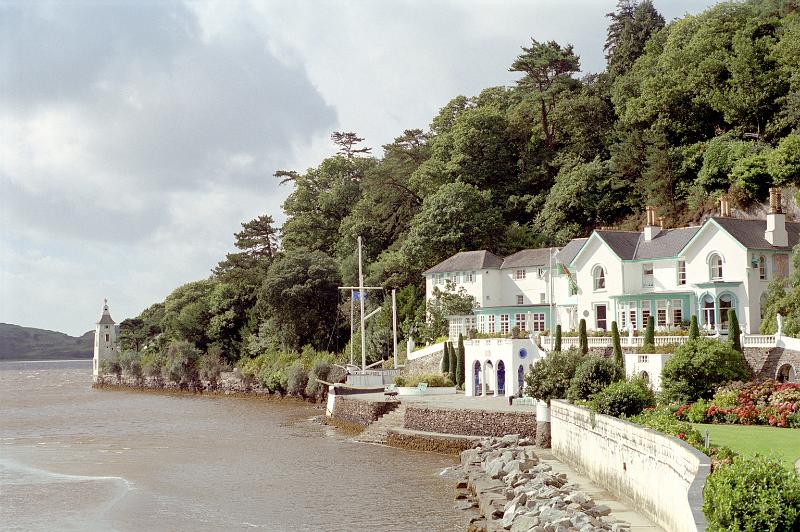 Scenic coastal landscape of the Portmeirion Hotel, Gwynedd, North Wales, overlooking the water amidst lush greenery