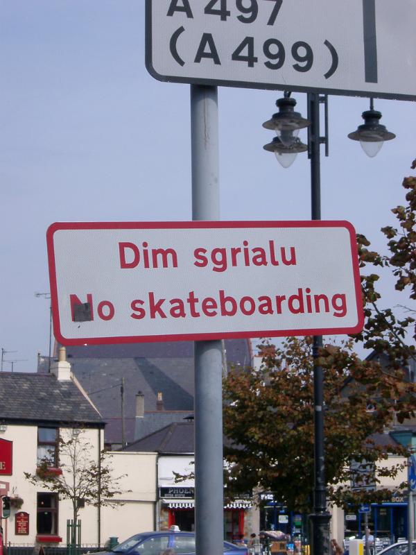 Close Up of Bi-lingual Welsh and English No Skateboarding Sign in Urban Setting