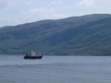 Commercial Fishing Sea Trawler on Scottish Loch with Hills in Background