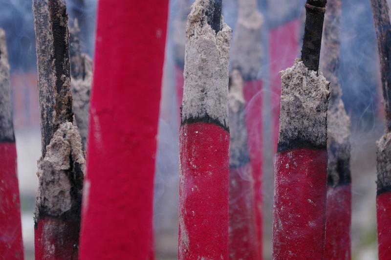 Close up of aromatic burning incense sticks or joss sticks in a Chinese Buddhist temple