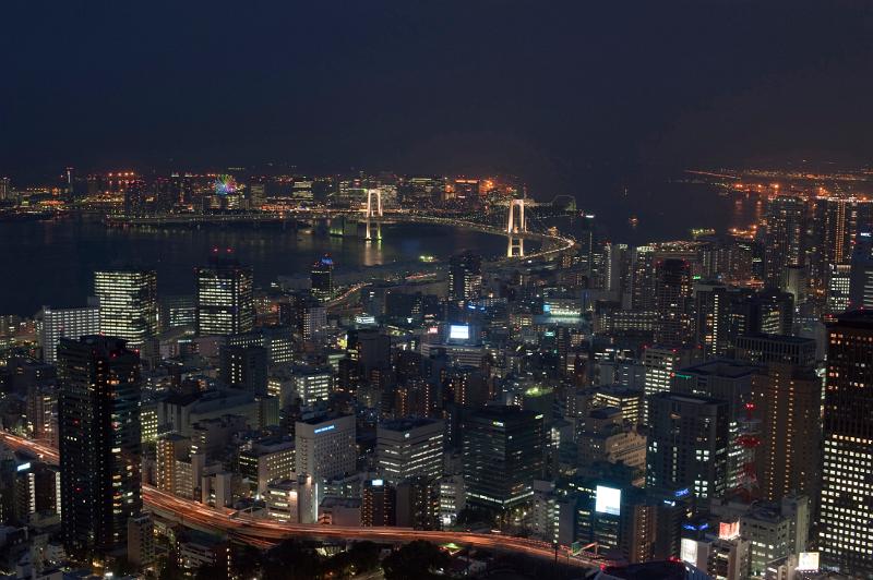 aerial view of tokyo at night featuring the rainbow bridge