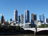 Architectural High Rise Buildings at Melbourne Central Business District Skyline on Light Blue Sky Background.
