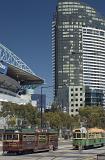 The Telstra Dome in The Docklands, Melbourne, Australia with street trams and a skyscraper in a busy street scene
