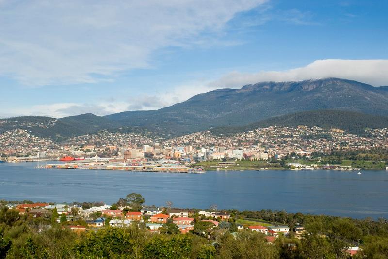 a panoramic view of hobart with mount wellington shrouded in cloud to the rear