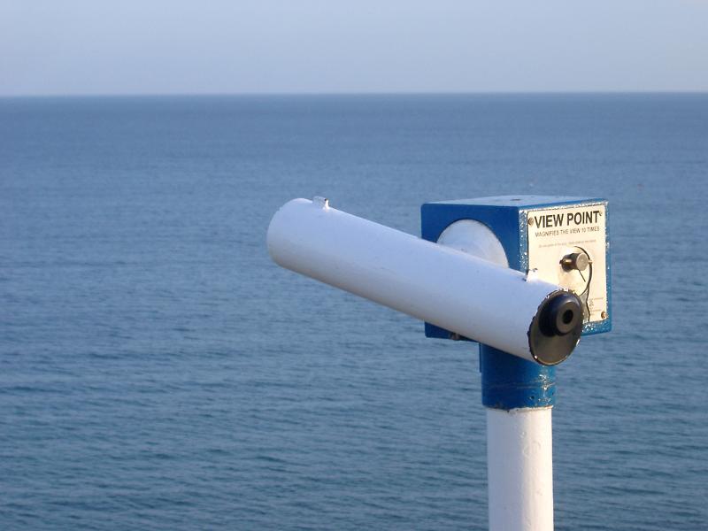 Telescope at the coast overlooking the sea for tourists to view the ocean, coastline and passing ships