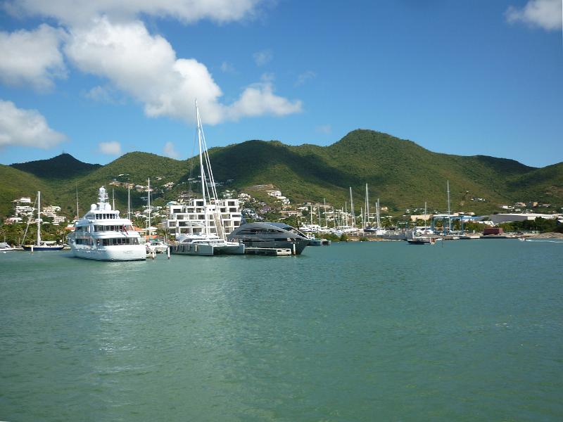 a line of expensive motor yachts, docked at the island of st maarten