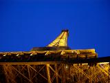 Looking Up at Eiffel Tower with Lights On Against Blue Night Sky, Paris, France