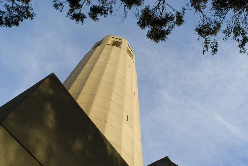 Famous Old Vintage Coit Tower in Worms Eye View Isolated on Light Blue Sky Background.