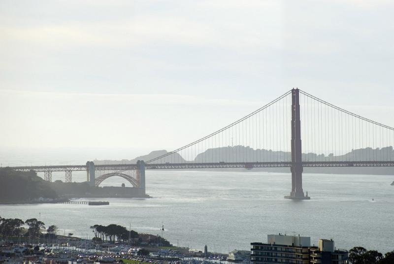Famous Long Golden Gate Bridge in San Francisco. Against a Very Light Blue White Sky Background.