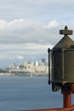 Macro Vintage Metallic Object From Golden Gate Bridge. Isolated on Blue Water Bay and Lighter Blue Sky Background.