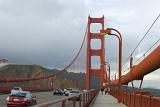 Walk Along the Golden Gate Bridge San Francisco. Captured with Mountains in the distance with a Stormy Sky Background.