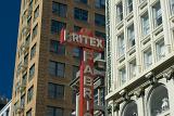 San Francisco architecture with a view of the external facades of offices and apartments above commercial stores with signage for Britex