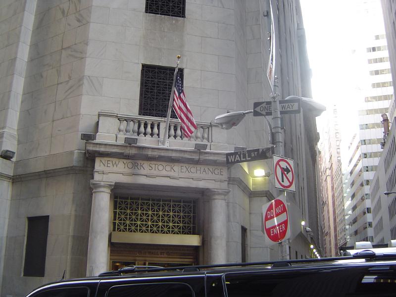 Old Vintage New York Stock Exchange Building with Small American Flag and Signage in Front at Wall Street