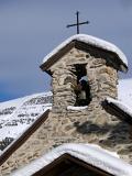 Historic Alpine Church, Covered with Snow, with Vintage Bells and Cross