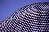 Close up on the cladding of the Selfridges Building at Birmingham Bullring Shopping Center on a Sunny Day with Blue Gray Sky Background.
