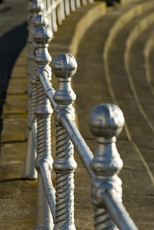 silver painted historic iron railings on the side of blackpool prom