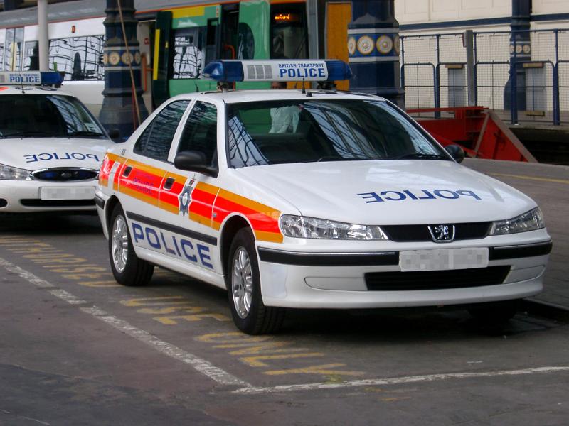 Brighton police patrol car parked in a reserved bay in an urban environment with a second patrol car behind