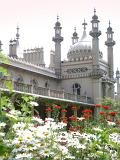 Onion dome and minarets of the Brighton Royal Pavilion viewed across a bed of summer flowers with white daisies in the foreground