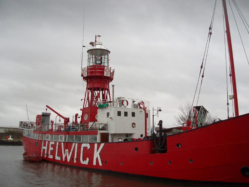 Historical Red Helwick Lightship at the Dock of Cardiff Bay, Wales. Captured on a Gray Sky Background.