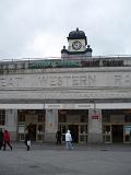 Cardiff Central Station with the clock tower above and Great Western Railway on the building facade, people entering the doors