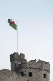 the welsh national flag flying proudly from the top of cardiff castle