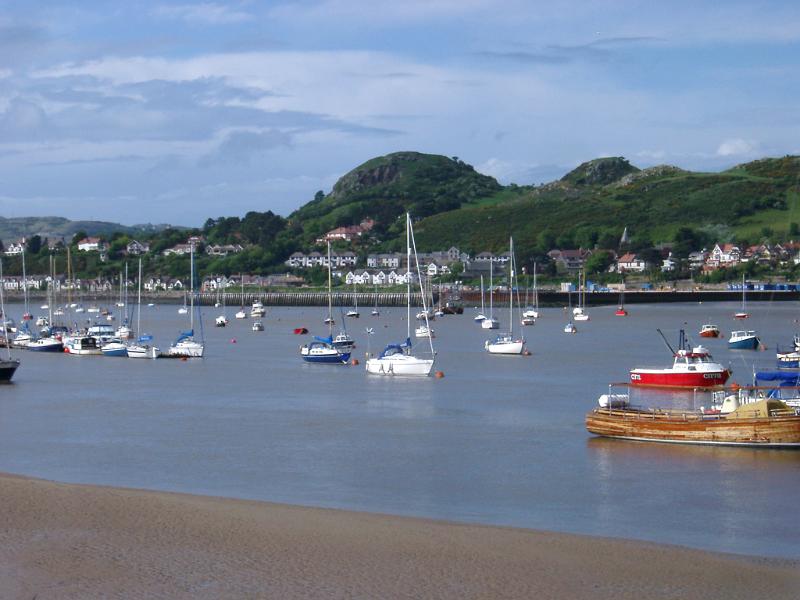 Various Small Boats at Famous Conwy River in Wales. Captured with Hills Afar.